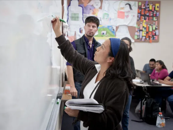 Woman in class room at a whiteboard